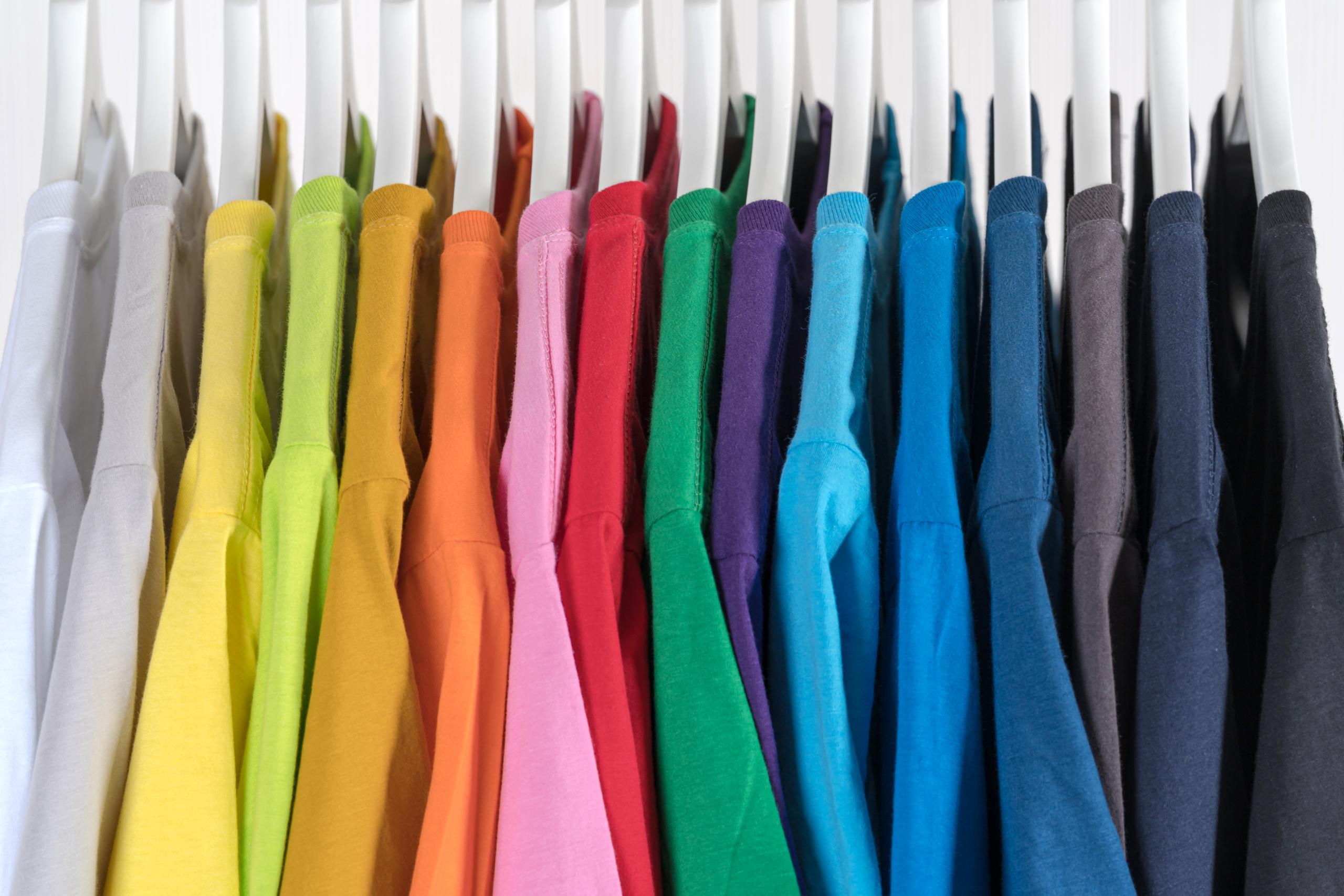 Close,Up,Of,T shirts,,Clothes,On,Hangers,On,White,Background